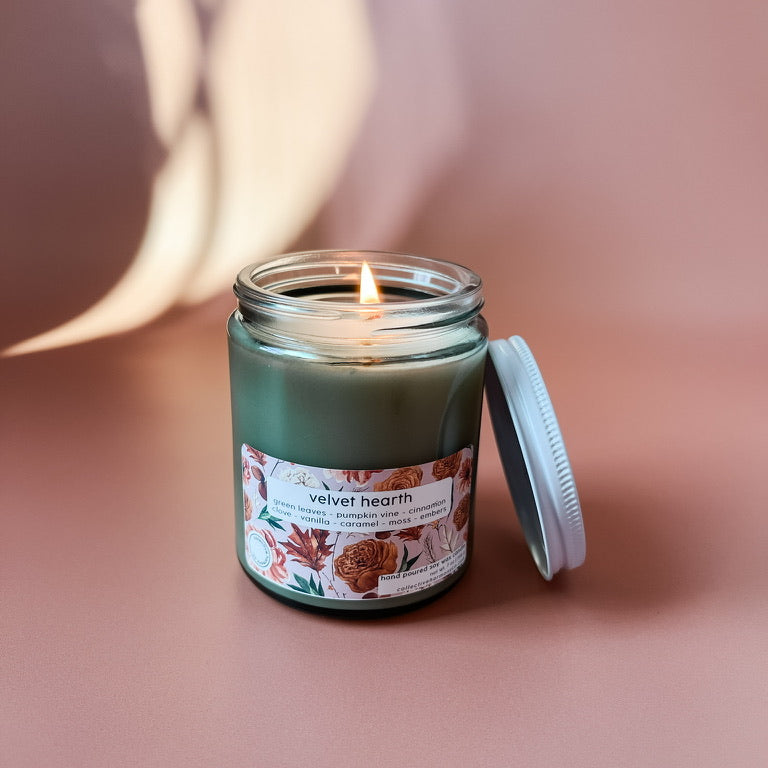 Candle in a glass jar with a label on a pink background